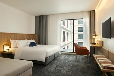 a hotel room with a bed and a window at ASAI Bangkok Chinatown in Bangkok
