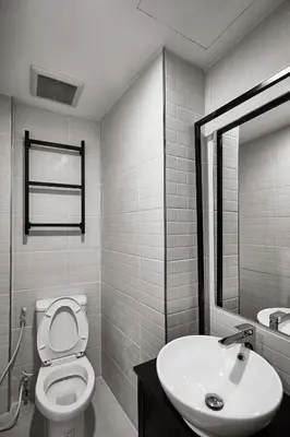 a bathroom with a toilet and a sink at Livinn91 Hotel in Bangkok
