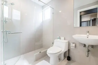 a bathroom with a toilet and a sink and a shower at MIQ Asoke202 Pool Villa - Asoke BTS 16 Pax in Bangkok