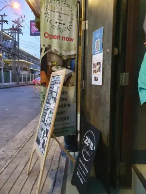 an open now sign in the window of a store at Baan Wualamphong บ้านวัวลำพอง in Bangkok