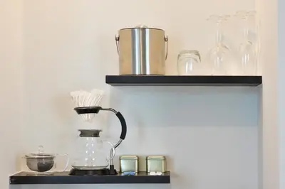 a shelf with glasses and a blender on it at Villa De Pranakorn in Bangkok