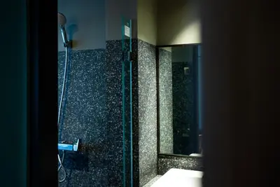 a bathroom with a shower with a mirror at The Spades Private Residence in Bangkok