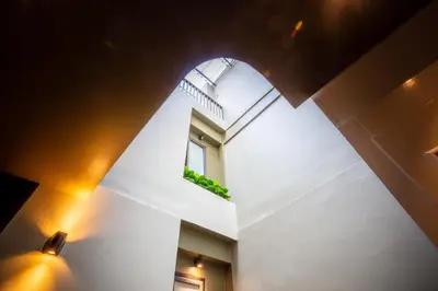 a room with a window and a white wall at The Spades Private Residence in Bangkok