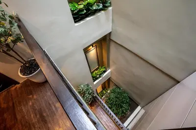an overhead view of a staircase with potted plants at The Spades Private Residence in Bangkok