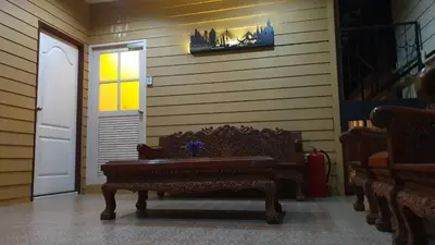 a room with a bench and a door with a picture on the wall at Papermoon Guesthouse in Bangkok