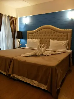 a bedroom with a large bed with a heart on it at @42 Residence in Bangkok