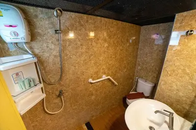 a bathroom with a shower with a sink and a toilet at @42 Residence in Bangkok