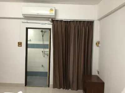 a bathroom with a shower with a shower curtain at @42 Residence in Bangkok