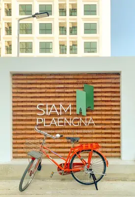 an orange bike parked in front of a building at Siamplaengna Residence in Bangkok