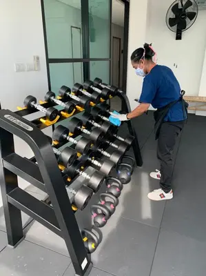 a man in a mask working on a gym equipment at Siamplaengna Residence in Bangkok
