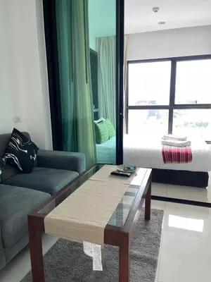 a living room with a couch and a coffee table at Siamplaengna Residence in Bangkok