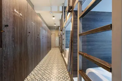 a bathroom with wooden walls and a walk in shower at Happy Station Bangkok in Bangkok