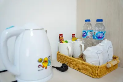 a counter with a jug of water and a basket of milk at ปลื้มจิต อพาร์ทเม้น บางใหญ่ in Nonthaburi