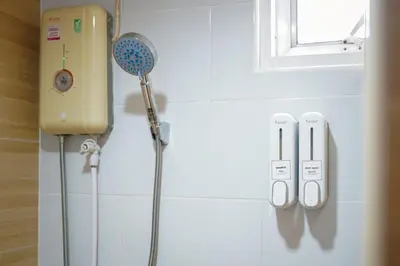 a shower with a shower head and a shower wand on a wall at ปลื้มจิต อพาร์ทเม้น บางใหญ่ in Nonthaburi