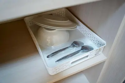 a white container and utensils in a drawer at ปลื้มจิต อพาร์ทเม้น บางใหญ่ in Nonthaburi