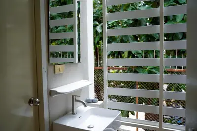 a bathroom with a sink and a mirror at ปลื้มจิต อพาร์ทเม้น บางใหญ่ in Nonthaburi