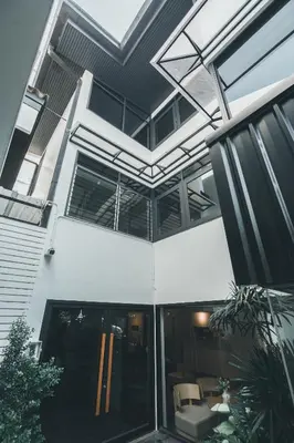 a house with a large glass door and windows at 41Cafetel in Bangkok