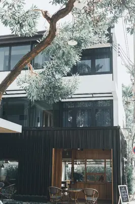 a building with a table and chairs in front of it at 41Cafetel in Bangkok