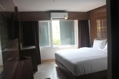 a bedroom with a bed and a window at H-District Boutique Poshotel in Bangkok