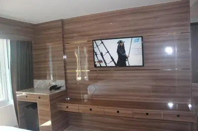 a room with a television on a wall at H-District Boutique Poshotel in Bangkok