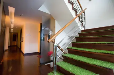 a staircase in a building with green plants at Snooze Hotel Thonglor Bangkok in Bangkok