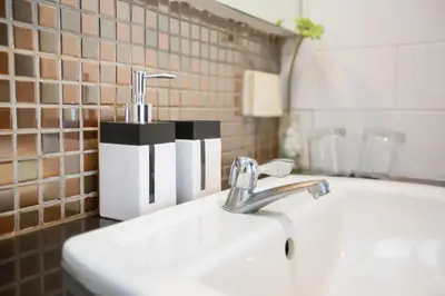 a sink with a faucet in a bathroom at Snooze Hotel Thonglor Bangkok in Bangkok
