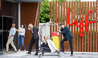 a group of people pushing a woman on a swing at lyf Sukhumvit 8 Bangkok in Bangkok