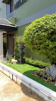 a garden with a vase in the middle of a yard at Million Mansion in Bangkok