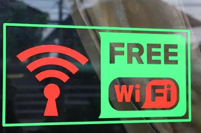 a sign in a window with a free wifi sign at Million Mansion in Bangkok