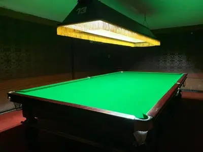 a green pool table in a room with a light at Million Mansion in Bangkok