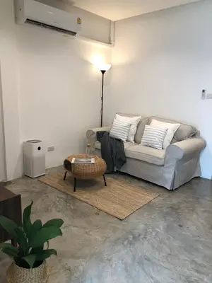 a living room with a couch and a table at Marlowe-Tony's home in Bangkok