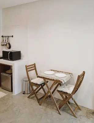 a kitchen with a table and two chairs and a counter at Marlowe-Tony's home in Bangkok