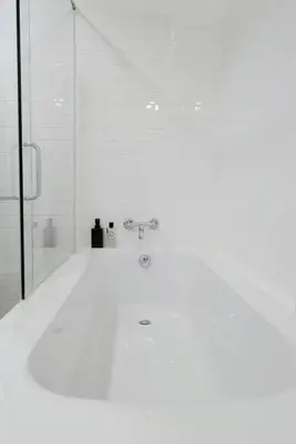 a white bathroom with a tub and a shower at Marlowe-Tony's home in Bangkok