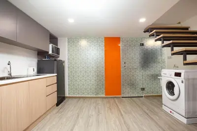 a kitchen with a washer and a washing machine at Hotel Z zpaze in Bangkok