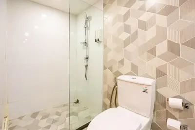 a bathroom with a toilet and a shower at Hotel Z zpaze in Bangkok