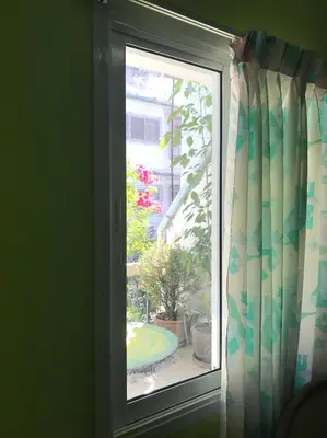 a window with a view of a garden outside at Swan inn 2 Nana in Bangkok