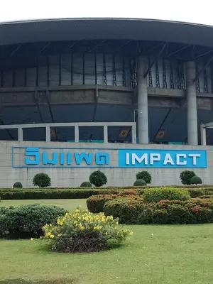 a building with a blue sign in front of it at Impact Don Mueang Bangkok Guest House For 3 Pax in Nonthaburi