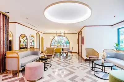 a lobby with couches and tables and chairs at The Cotton Saladaeng Hotel in Bangkok