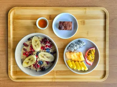 a tray with two plates of breakfast food on it at The Cotton Saladaeng Hotel in Bangkok