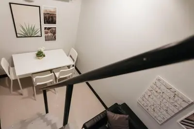 a white table and chairs in a white room at S1 Large Duplex Silom 3 Beds, Full Kitchen WIFI in Bangkok