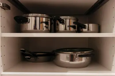 two pots and pans on shelves in a kitchen at S1 Large Duplex Silom 3 Beds, Full Kitchen WIFI in Bangkok