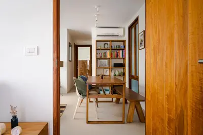 a dining room with a table and a book shelf at APT476 in Bangkok