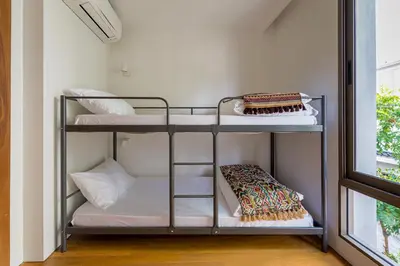 a room with two bunk beds with a window at APT476 in Bangkok