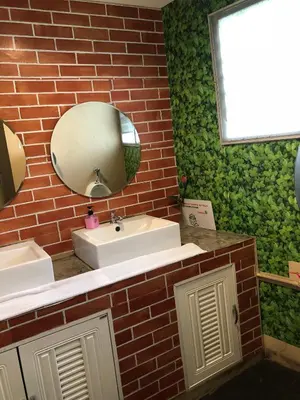 a bathroom with a white sink and a mirror at VX The Fifty in Bangkok