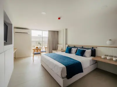 a bedroom with a large bed with blue pillows at Blu 395 in Bangkok