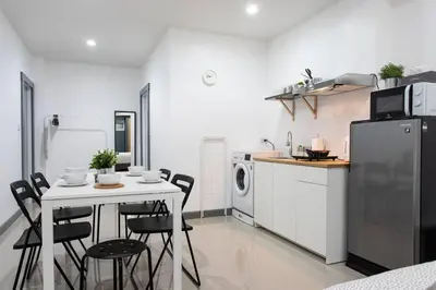 a kitchen with a table and chairs and a refrigerator at P1 Silom Pan large room full kitchen WIFI 4-6pax in Bangkok