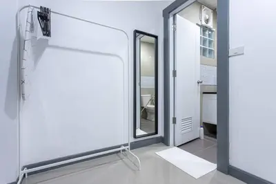 a bathroom with a glass door and a mirror at P1 Silom Pan large room full kitchen WIFI 4-6pax in Bangkok