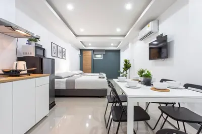 a kitchen and living room with a bed and a table and chairs at P1 Silom Pan large room full kitchen WIFI 4-6pax in Bangkok