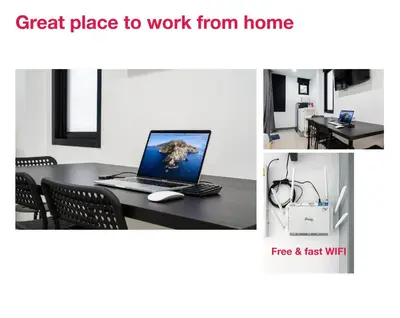 a table with a laptop computer on top of it at P1 Silom Pan large room full kitchen WIFI 4-6pax in Bangkok