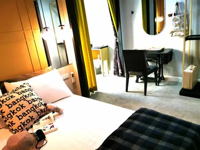 a bedroom with a bed and a piano in a room at Chomm House in Bangkok